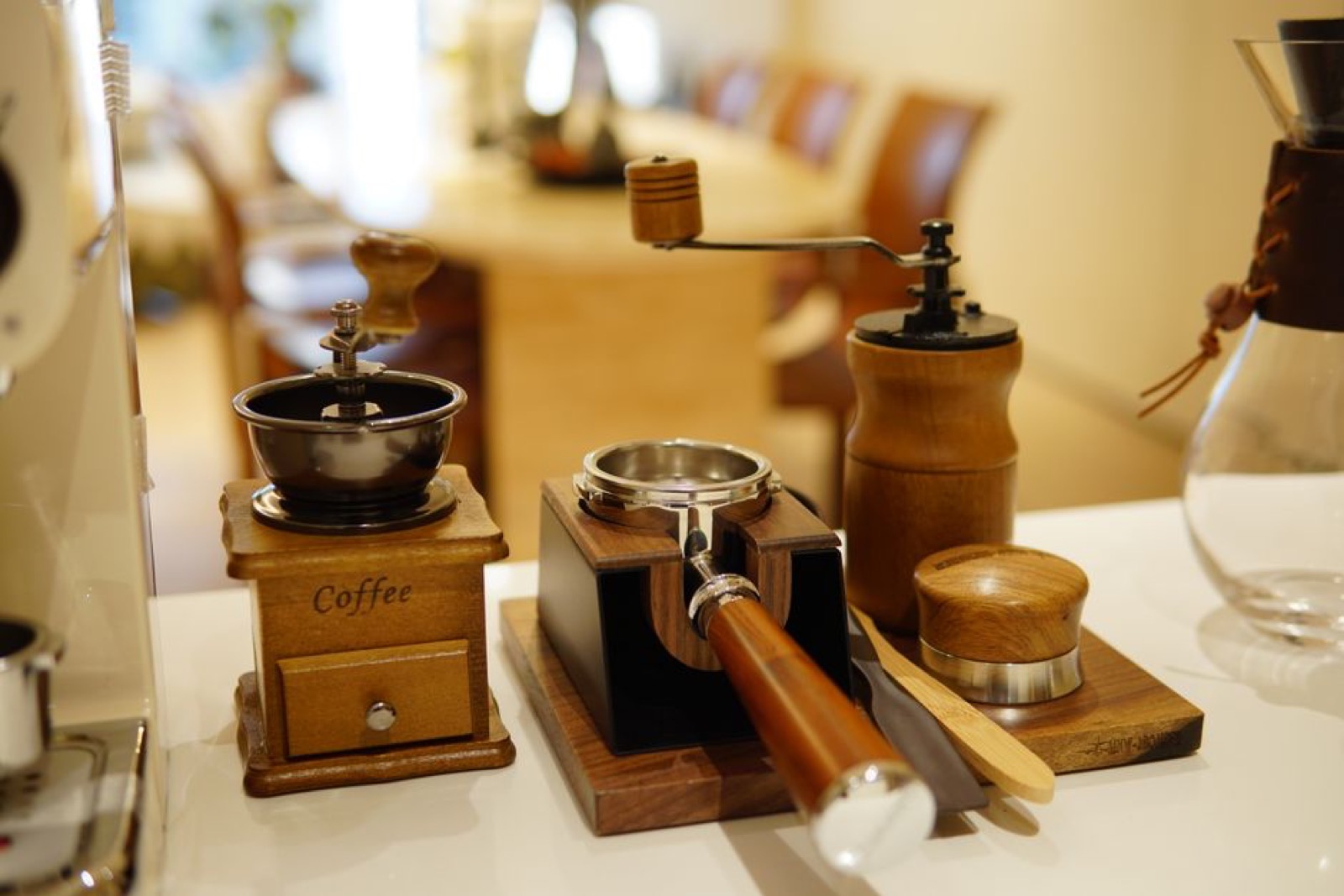 Espresso grinder setup with portafilter and tamper on a cafe counter