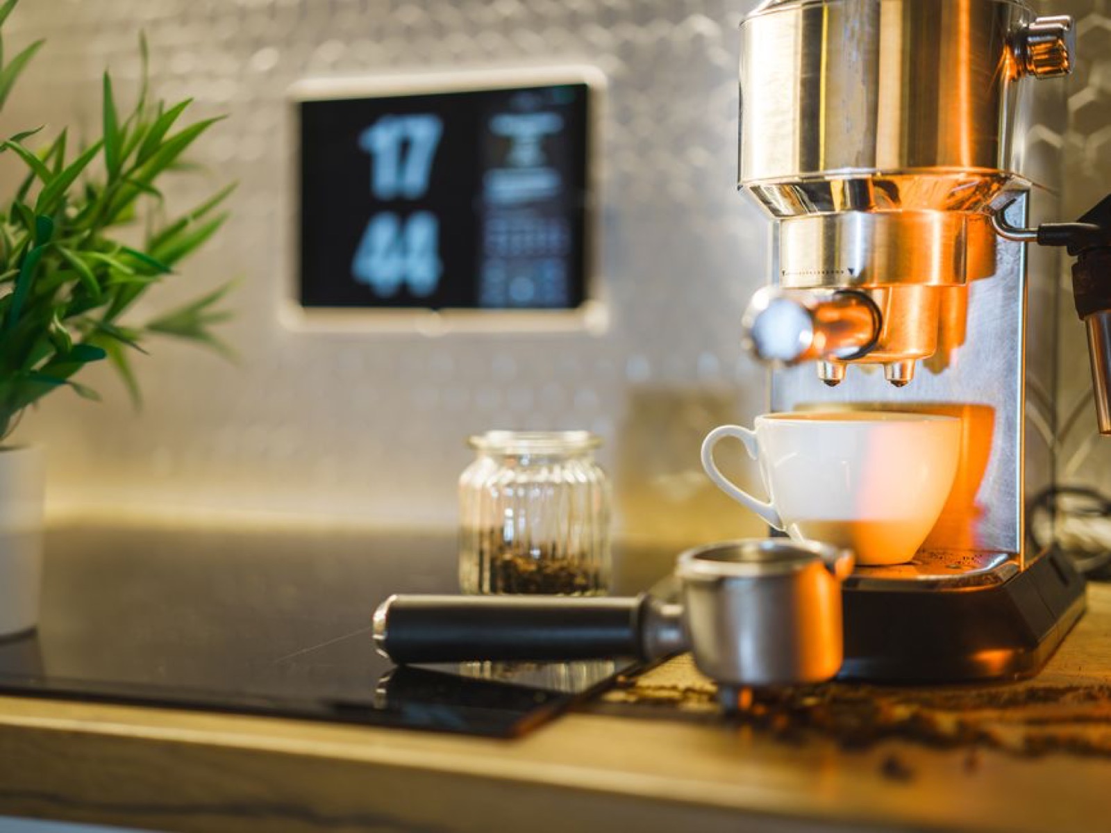 Espresso machine pulling a shot on a home kitchen counter with portafilter and coffee beans