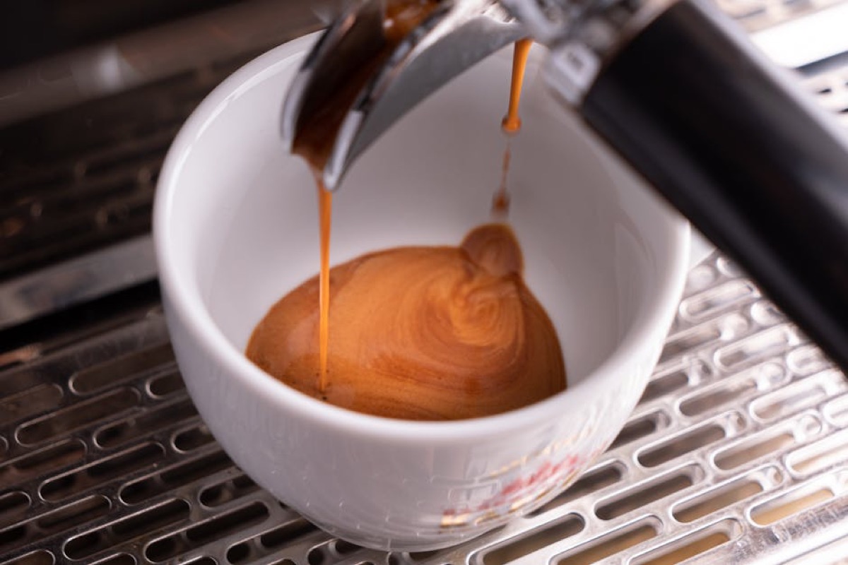Espresso shot with rich crema pouring from machine